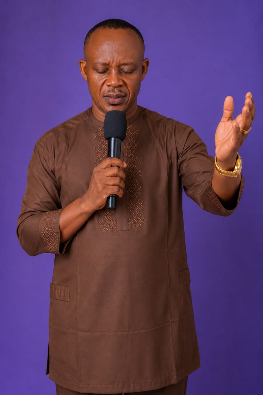 Pastor Goodluck ministering in prayer